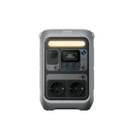 The Anker C300 DC placed next to a laptop to highlight its 30% smaller footprint.