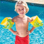 Child wearing inflatable arm floats with dinosaur design in a pool