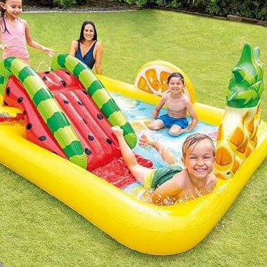Children playing on a colorful inflatable water slide and pool set outdoors.