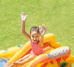 Child on a pineapple-shaped inflatable pool toy with a grassy background