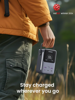 Person holding a power bank with 'Ugreen' branding, outdoor setting