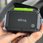 Portable power bank with '100W' marking held in a hand