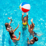 Children playing with a beach ball in a pool