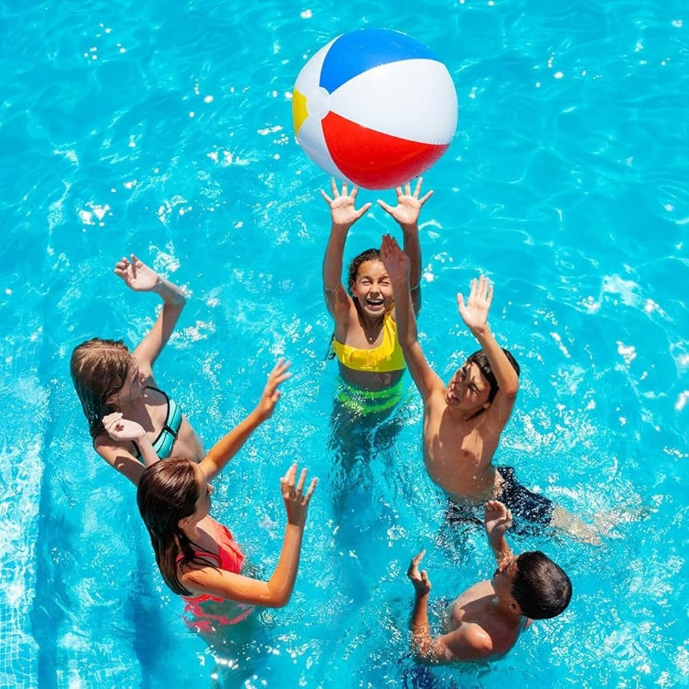 Children playing with a beach ball in a pool
