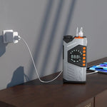 Portable power station with digital display on a wooden surface, plugged into an outlet.