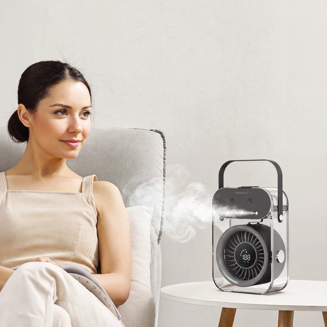 Woman sitting on a couch with a humidifier emitting steam in the background