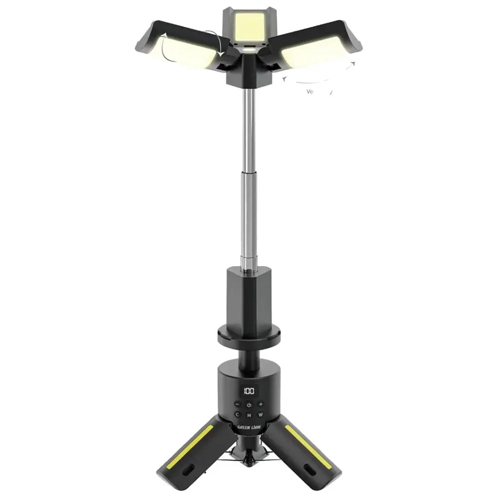 Black Green Lion Trio Beam Camping Light on tripod, extended, illuminating a dark campsite.