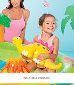 Woman and child on a inflatable pool toy with a dinosaur, surrounded by palm trees and a butterfly.