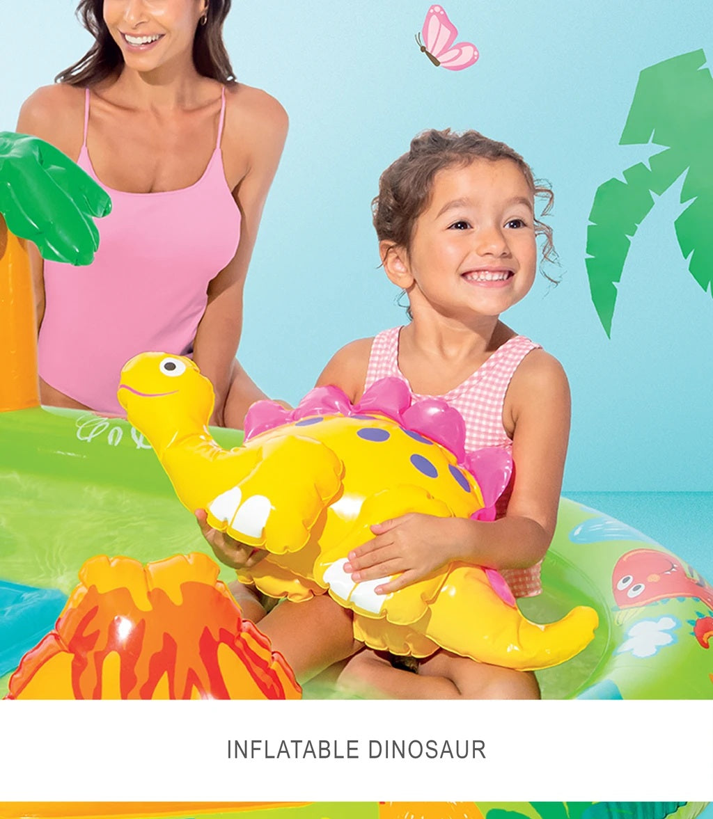 Woman and child on a inflatable pool toy with a dinosaur, surrounded by palm trees and a butterfly.