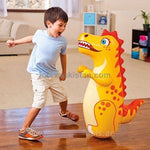 Child playing with an inflatable dinosaur toy in a living room.