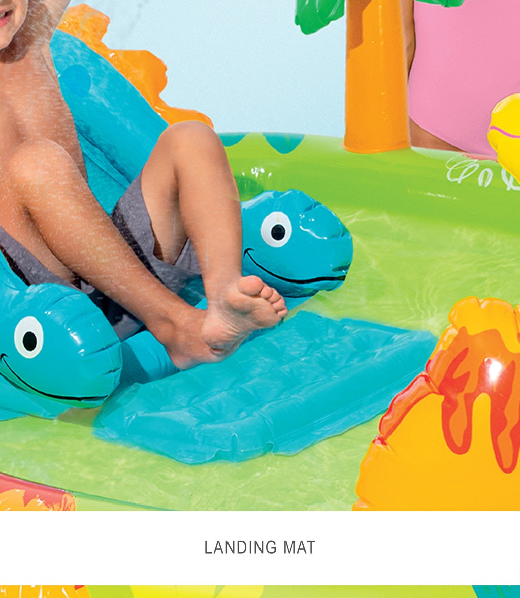 Inflatable play mat with dinosaur design on a grassy area