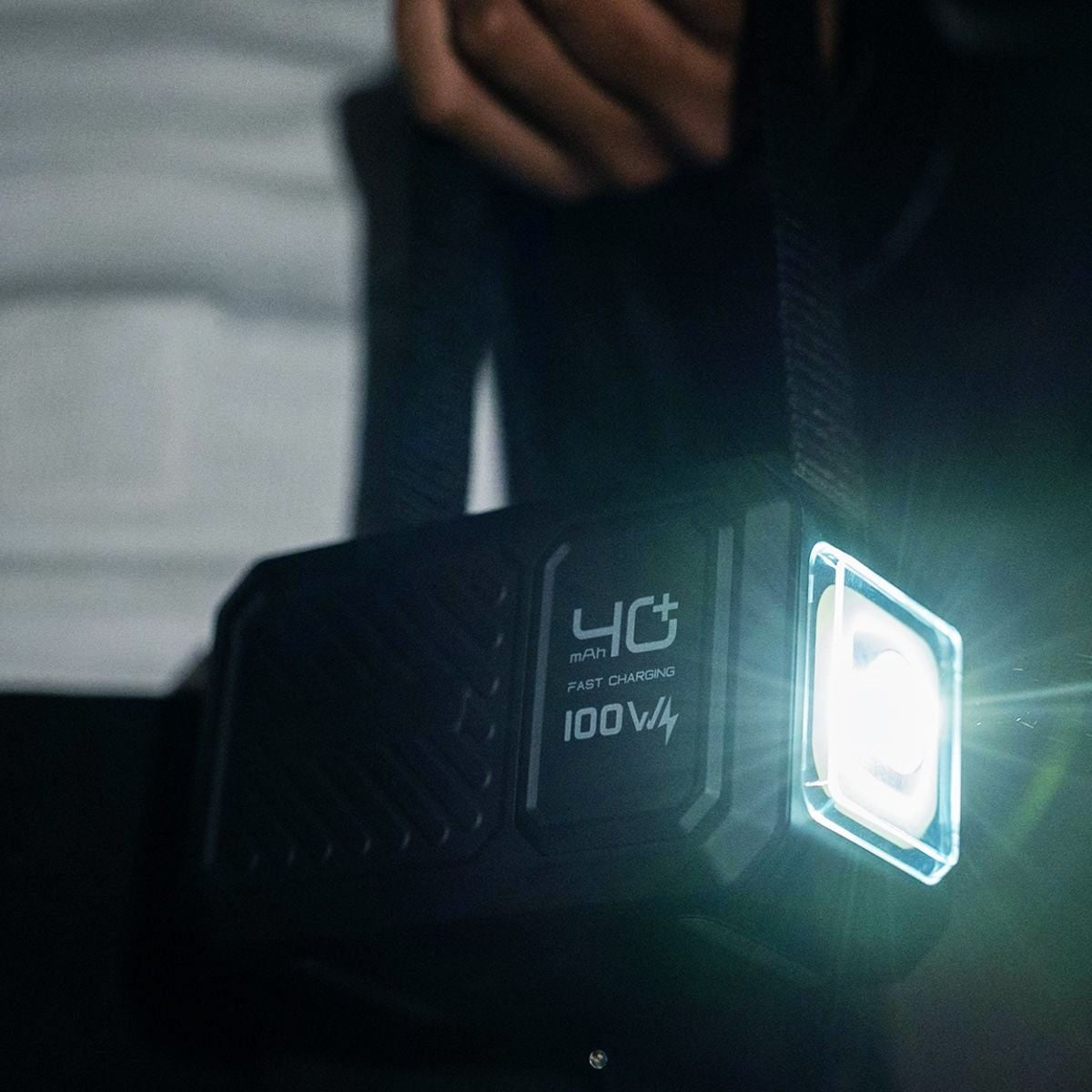 Electronic device with '4G' and '100V4' text on a dark background