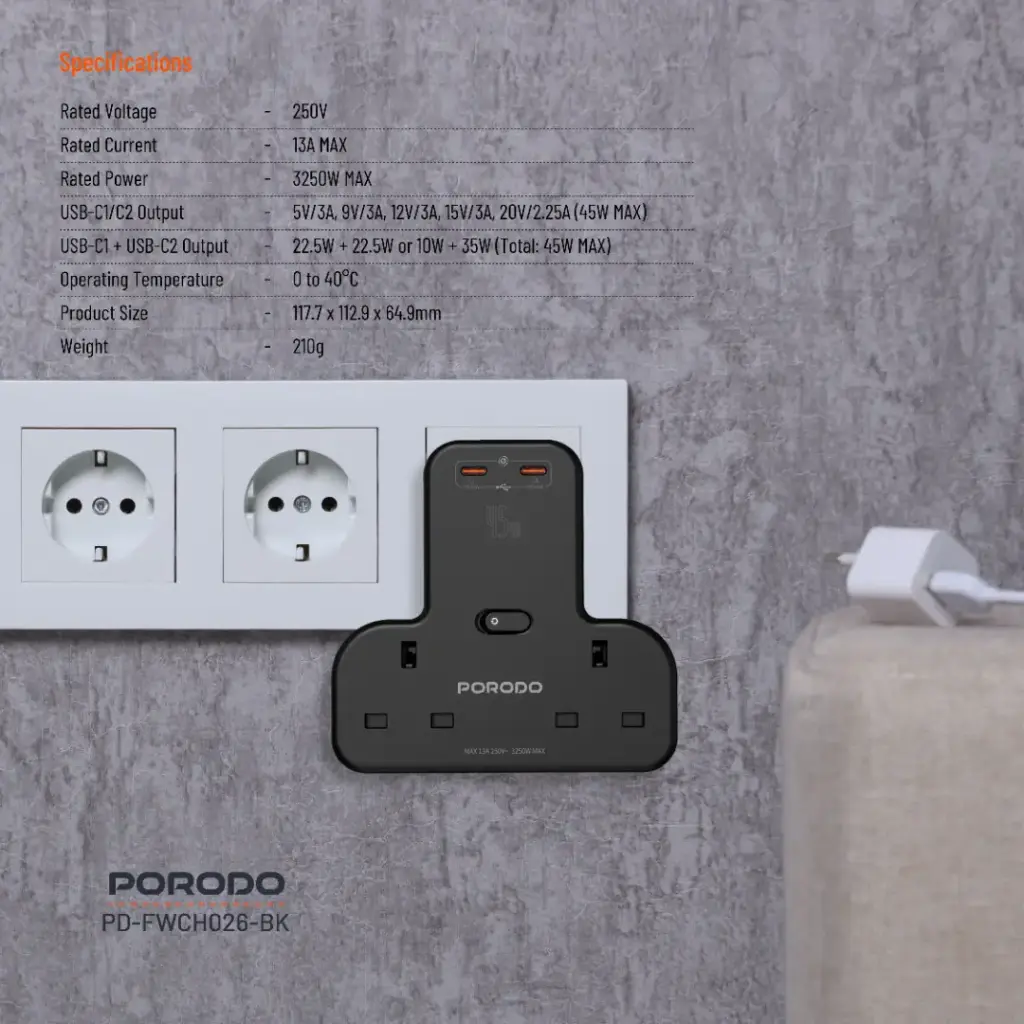 Black Porodo power adapter on a concrete wall with socket and cable.